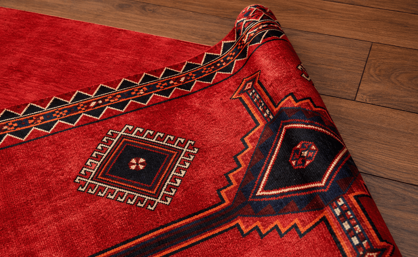 Handwoven heritage red carpet folded over warm artisanal wooden table